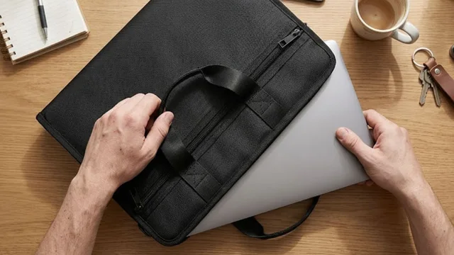 Laptop sliding into the Mr. Guardwell fireproof laptop bag on a desk